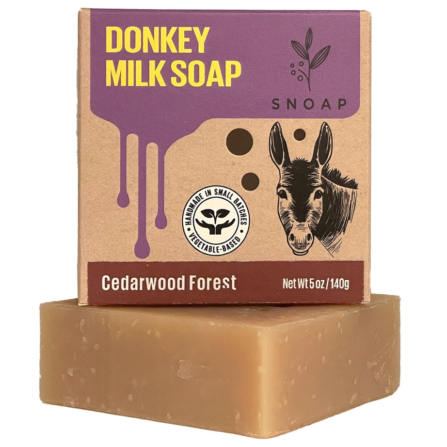 SNOAP Cedarwood Forest donkey milk soap bar beside its kraft carton.