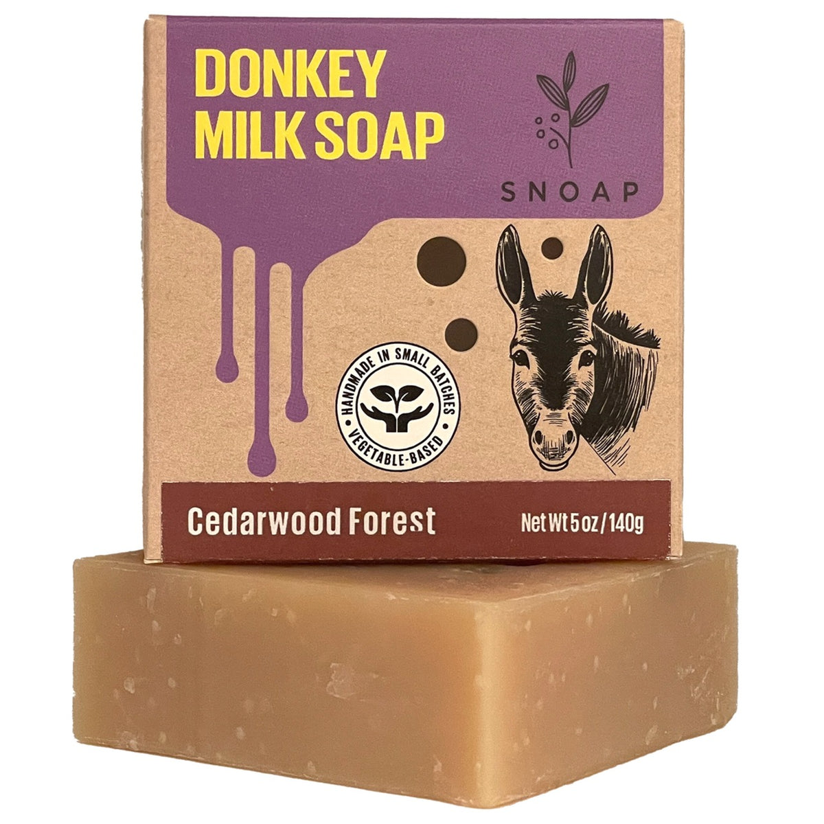 SNOAP Cedarwood Forest donkey milk soap bar beside its kraft carton.